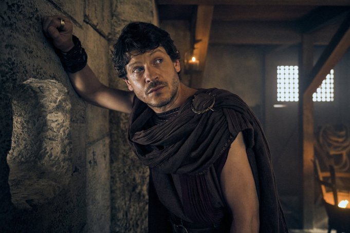 THOSE ABOUT TO DIE -- Episode 101 Pictured: (l-r) Iwan Rheon as Tenax -- (Photo by: Reiner Bajo/Peacock)