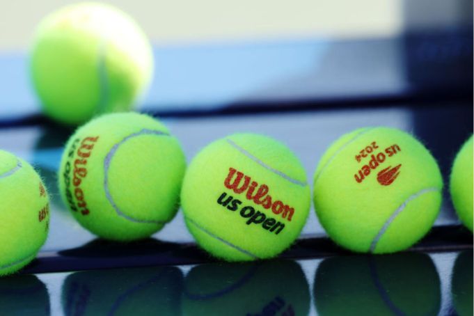 NEW YORK, NEW YORK - AUGUST 22: Detail of Wilson tennis balls with the US Open logo during a practice session prior to the start of the 2024 US Open at USTA Billie Jean King National Tennis Center on August 22, 2024 in the Flushing neighborhood of the Queens borough of New York City. (Photo by Sarah Stier/Getty Images)